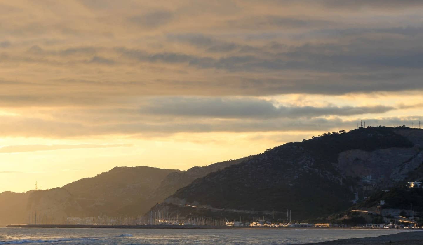 Castelldefels beach at sunset, with the marina and the Garraf massif in the distance