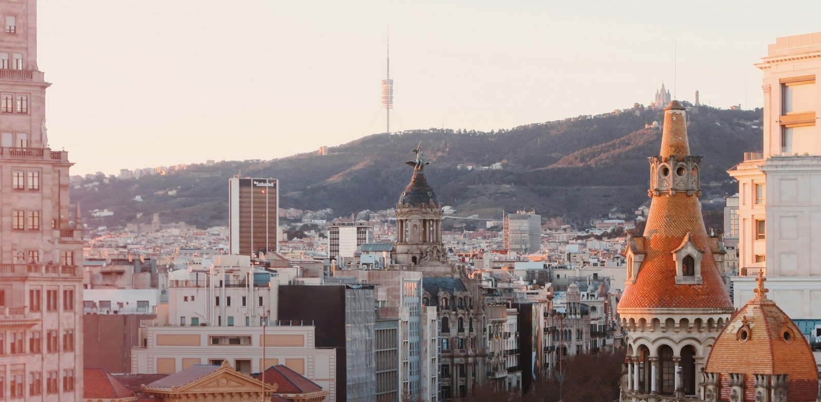 Mount Tibidabo with the Collserola tower, seen from central Barcelona at sunset