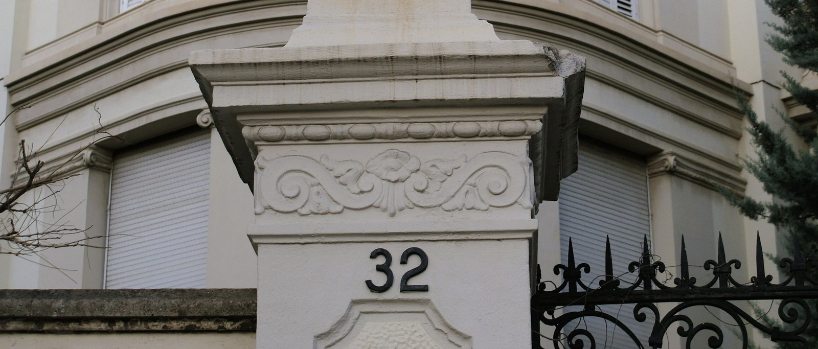The gate of number 32 on Avinguda Tibidabo: a wrought-iron lantern and the house number